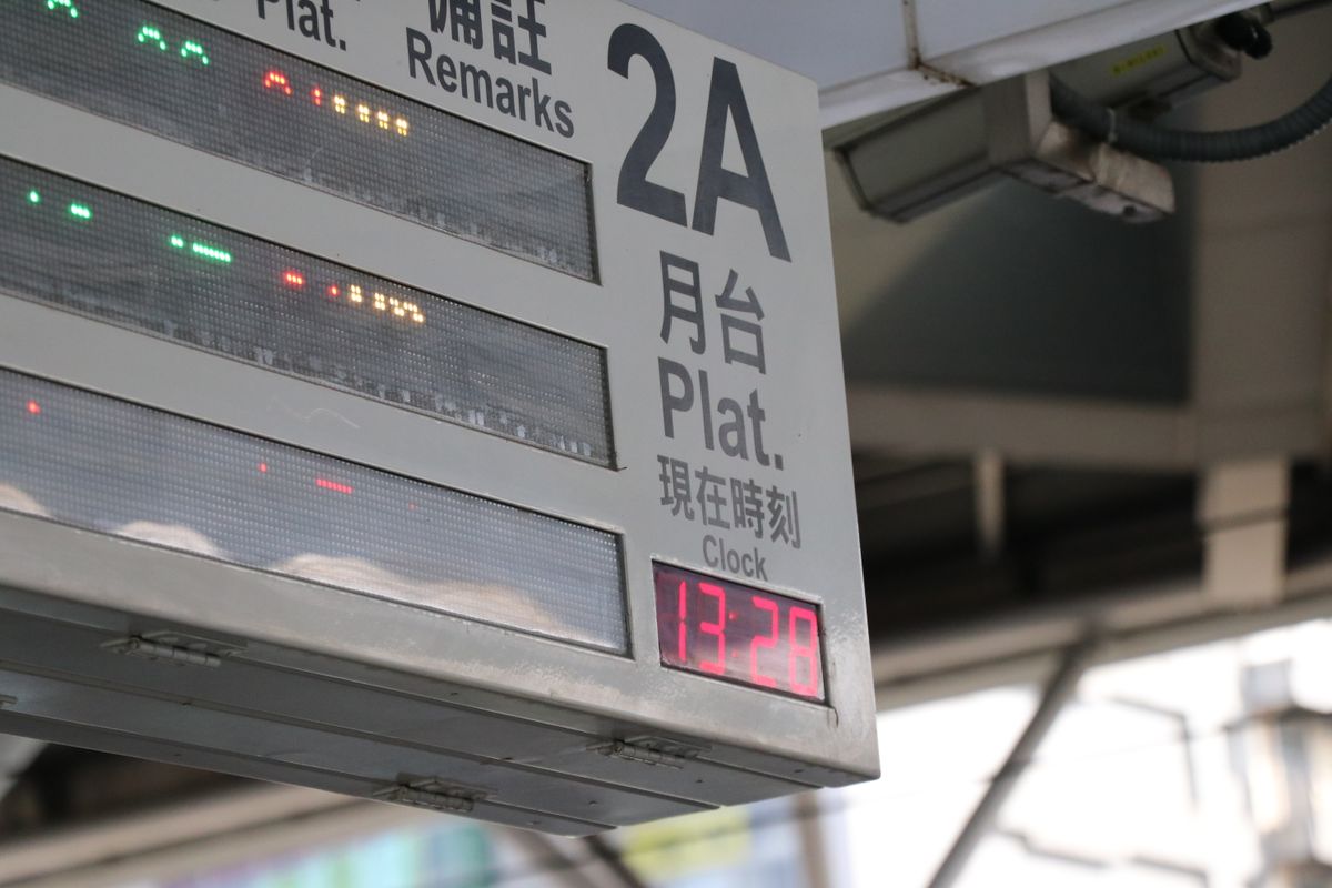 Airport information display board above a concourse