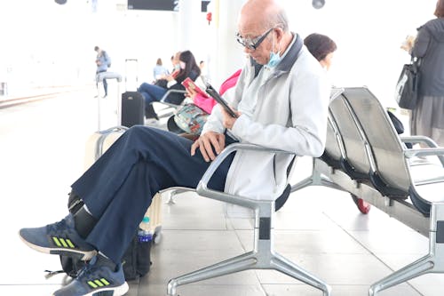 A Man in White Jacket Sitting on a Chair