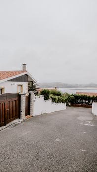 View of a serene street leading to the ocean in Cantabria, Spain, offering coastal charm and tranquility.