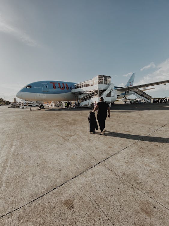 Free Person Walking Towards the Airplane Stock Photo