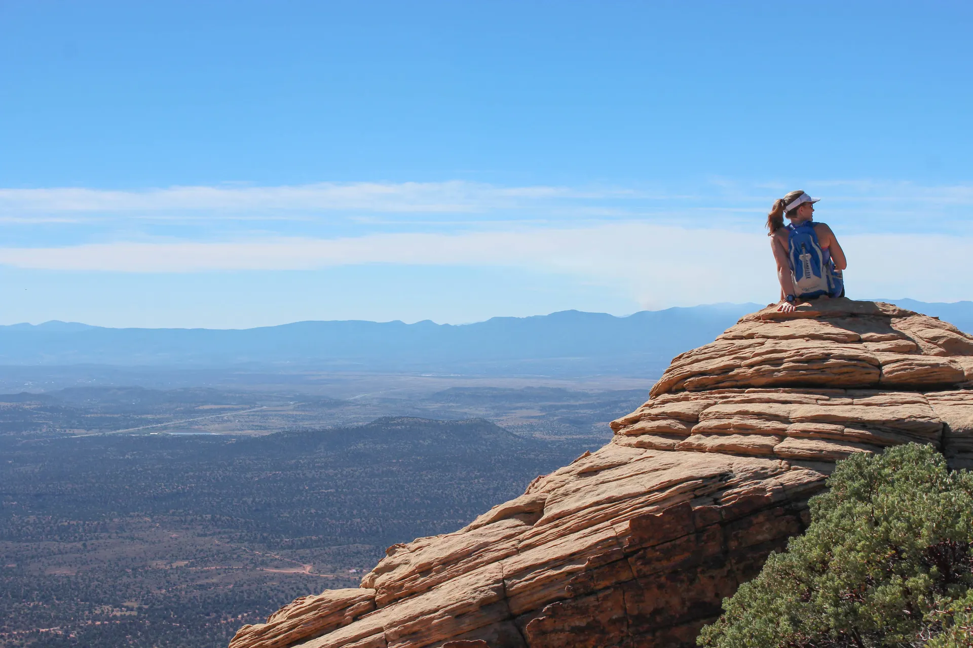 Woman sitting on top of a red rock formation in Sedona, Arizona Woman sitting on top of a red rock formation in Sedona, Arizona
