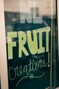 Inscription made with chalk on black board in glass shop window of modern building