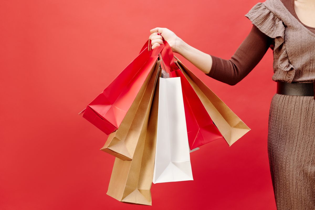Victoria's Secret Angel Credit Card Review - person holding shopping bags from retail purchases