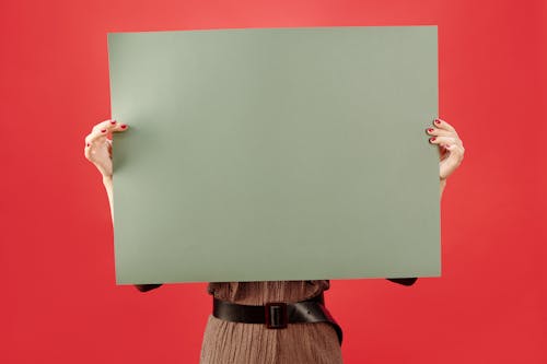 A Person Holding Green Blank Paper