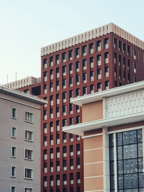 Free Modern urban scene with tall buildings displaying unique architectural designs. Stock Photo