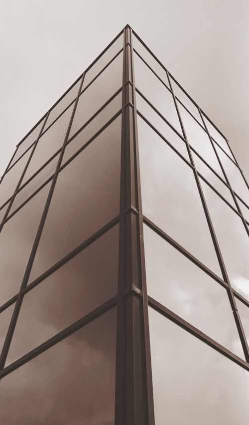Free Low angle view of a modern glass building with a cloudy reflection in Alkmaar. Stock Photo