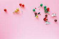 Red and Silver Beads on Pink Surface