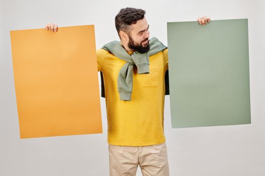 Man in Yellow Long Sleeve Shirt Holding Brown Folder