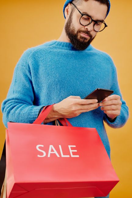 person checking voucher smartphone secondhand deal