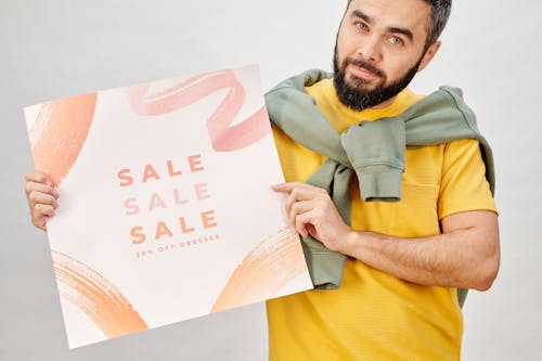 Free Man Holding a Sale Poster Stock Photo