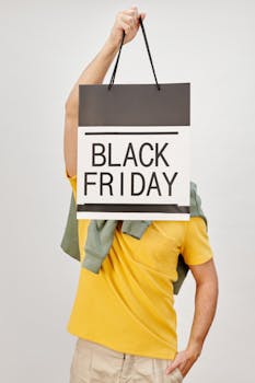 Person holding a Black Friday shopping bag, studio shot