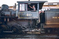 People in old locomotive on railroad