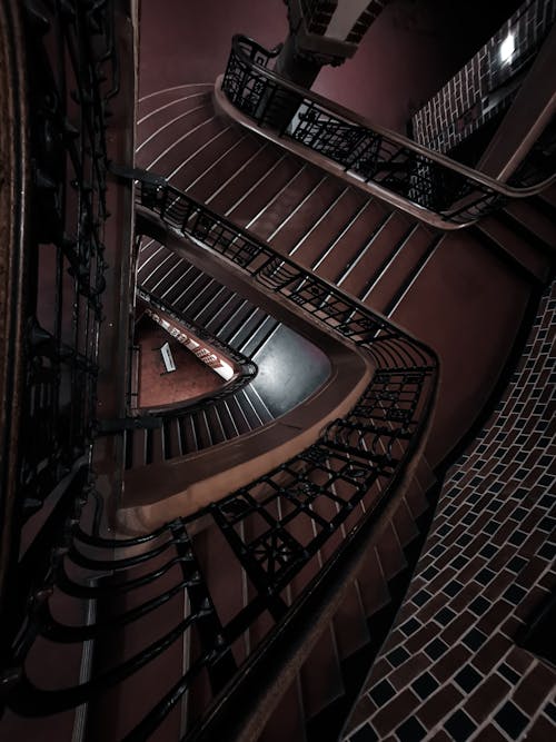 Free Brown Spiral Staircase With Brown Wooden Railings Stock Photo