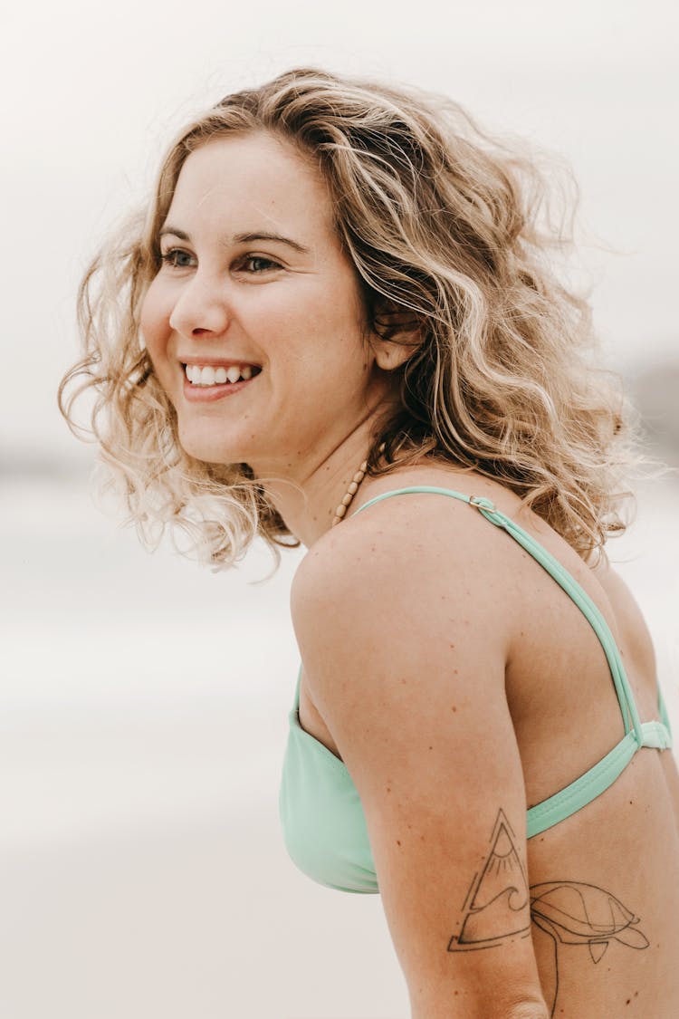 Happy Tattooed Traveler In Swimsuit On Shore