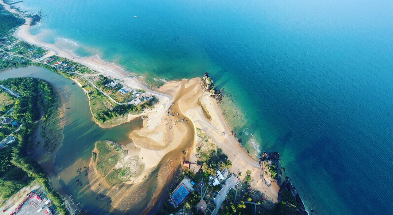 stunning aerial view of a beach and coastline with clear blue water