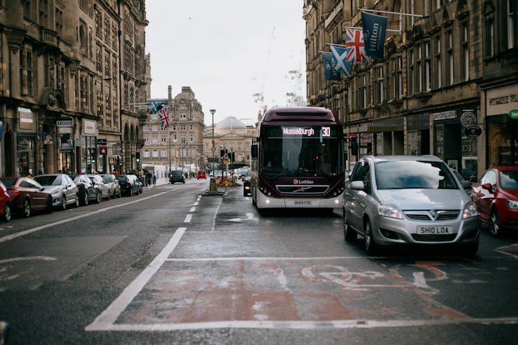 Road With Traffic Between Old Government Buildings In City