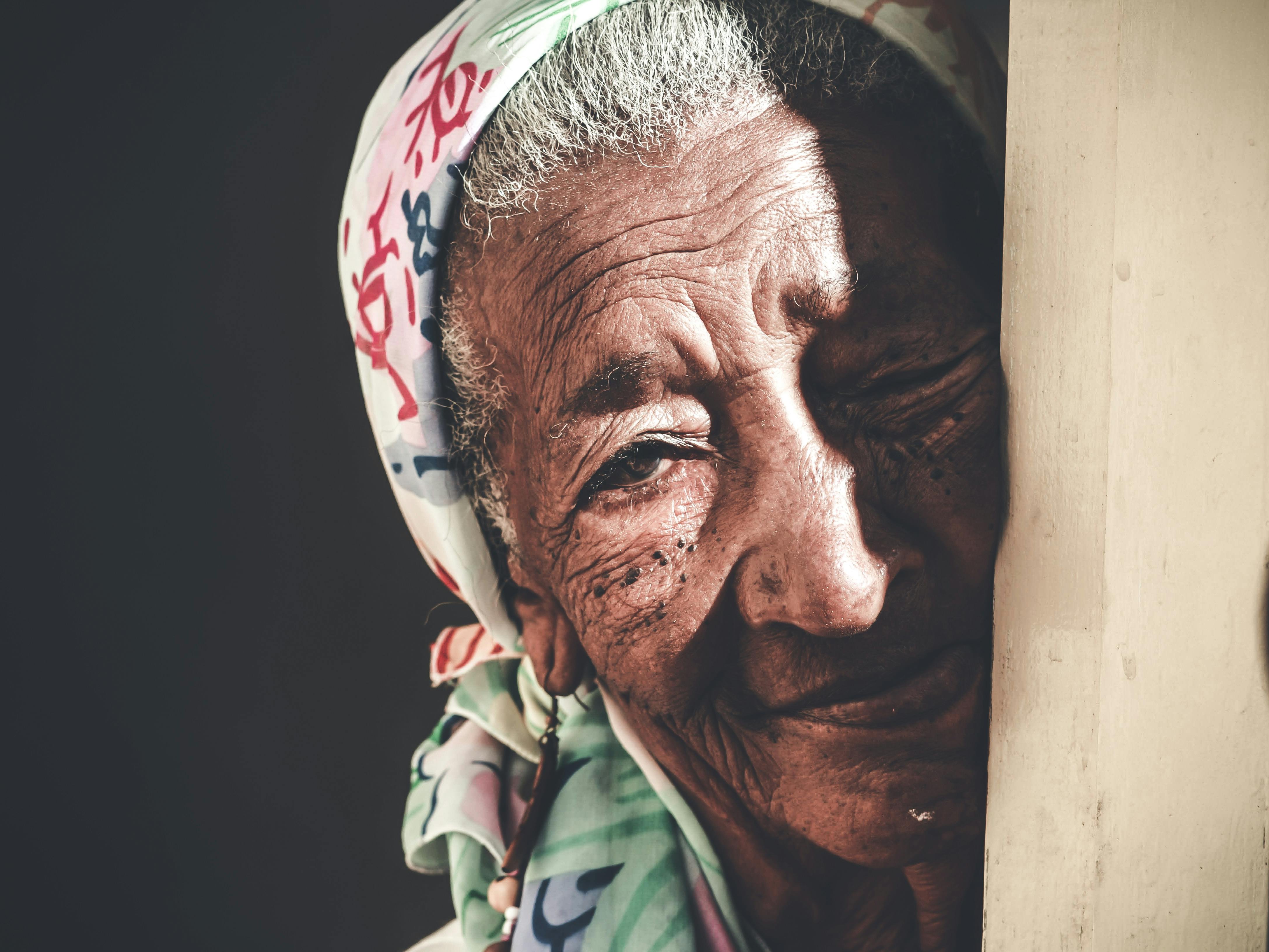 crop positive elderly asian woman in headscarf