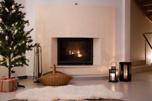 Free Green Christmas Tree Near the Fire Place Stock Photo