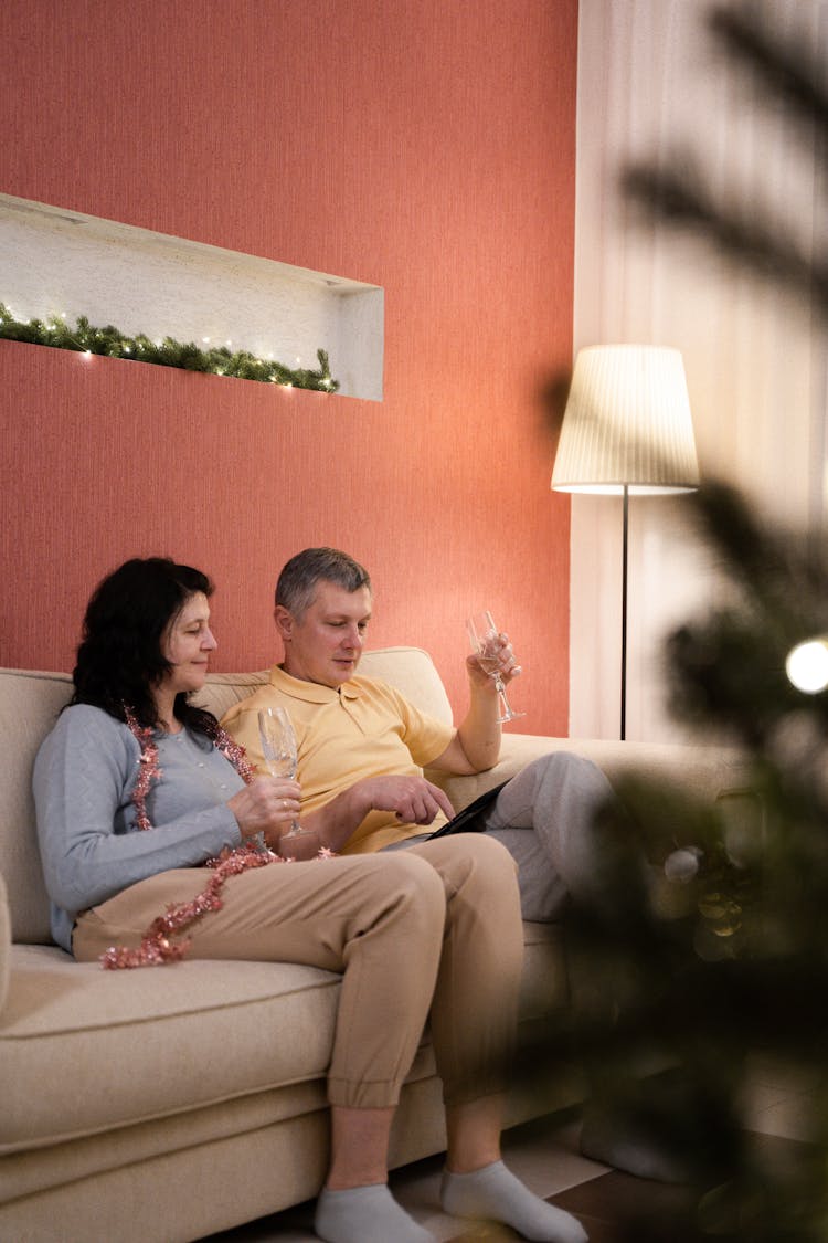 Couple Sitting On Couch Having A Video Chat