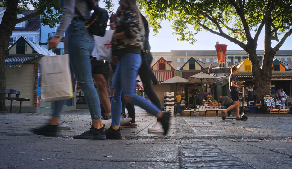 Fotomural Mercado callejero vibrante con personas comprando y disfrutando de la animada atmósfera.