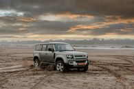 A Motor Vehicle Driving on Brown Sand