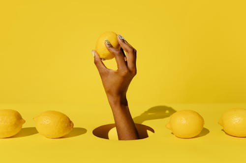 Gratis lagerfoto af citroner, citrusfrugt, gul baggrund