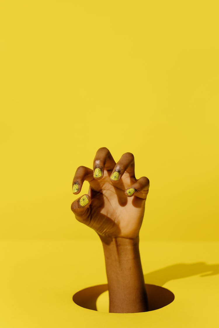 Person With Yellow Nail Polish