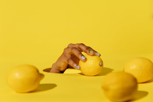 Photo of Hand and Lemons