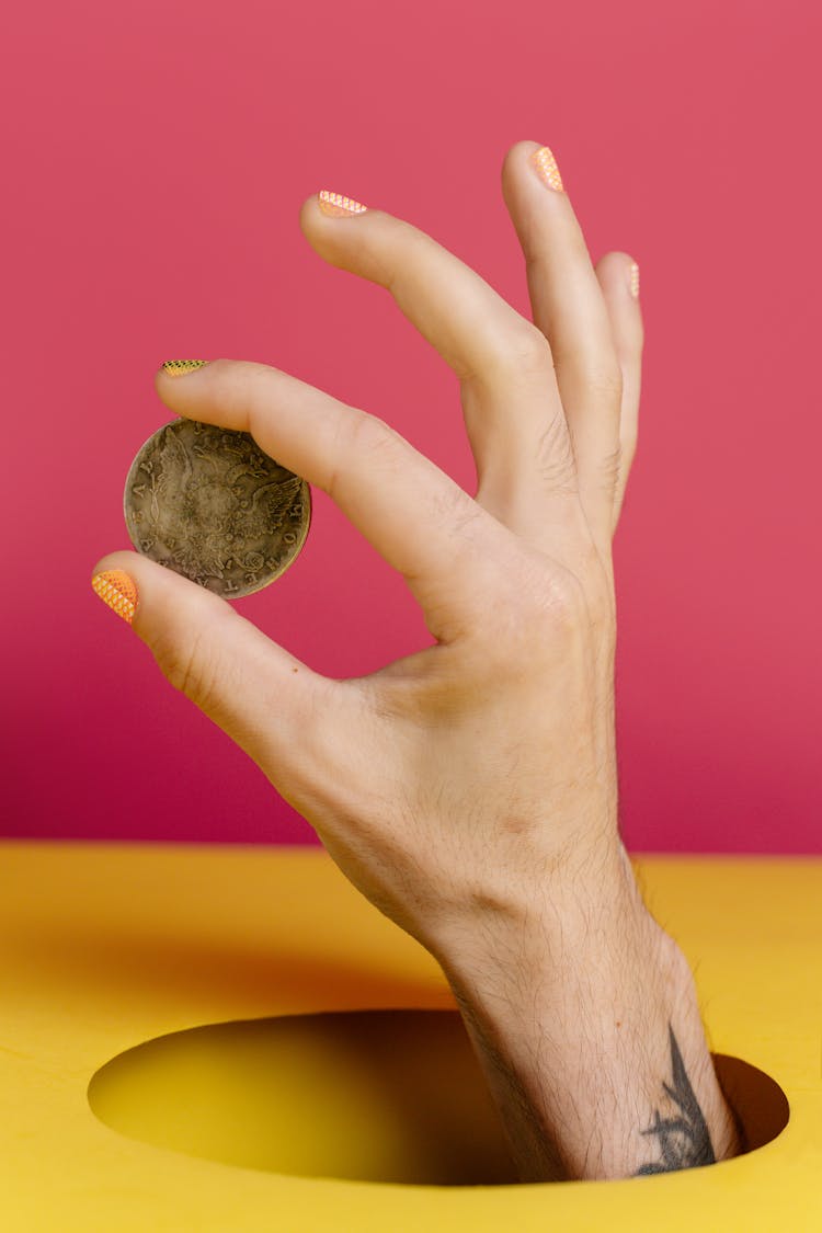 Hand Holding A Coin