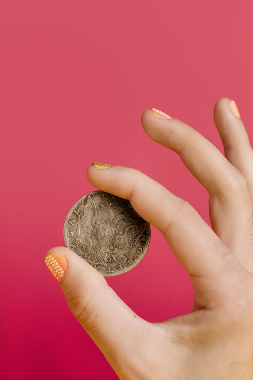 Person Holding a Round Coin