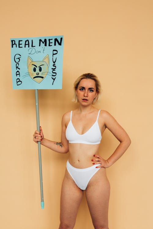 Woman in White Underwear Holding Placard on Stick · Free Stock Photo