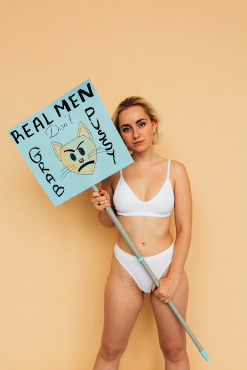 Free Woman Wearing Underwear Holding a Placard on Stick Stock Photo