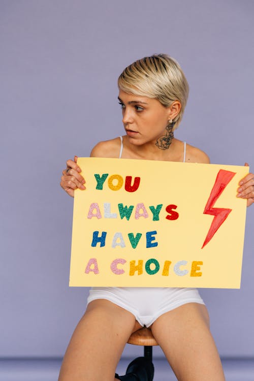 Free Woman with Short Hair Holding a Placard Stock Photo