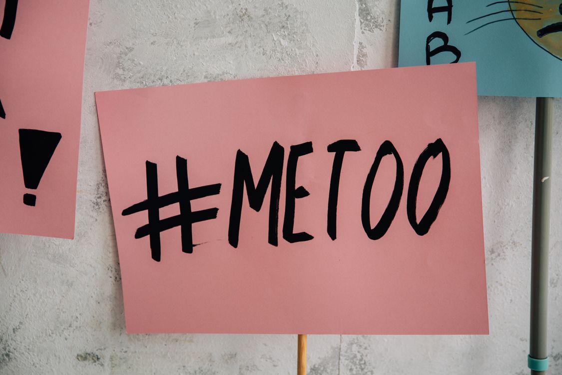 Me Too Poster on Wooden Stick Against White Wall · Free Stock Photo