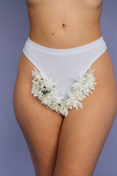 Free Close-up of white floral decorated underwear on woman, artistic fashion shot Stock Photo