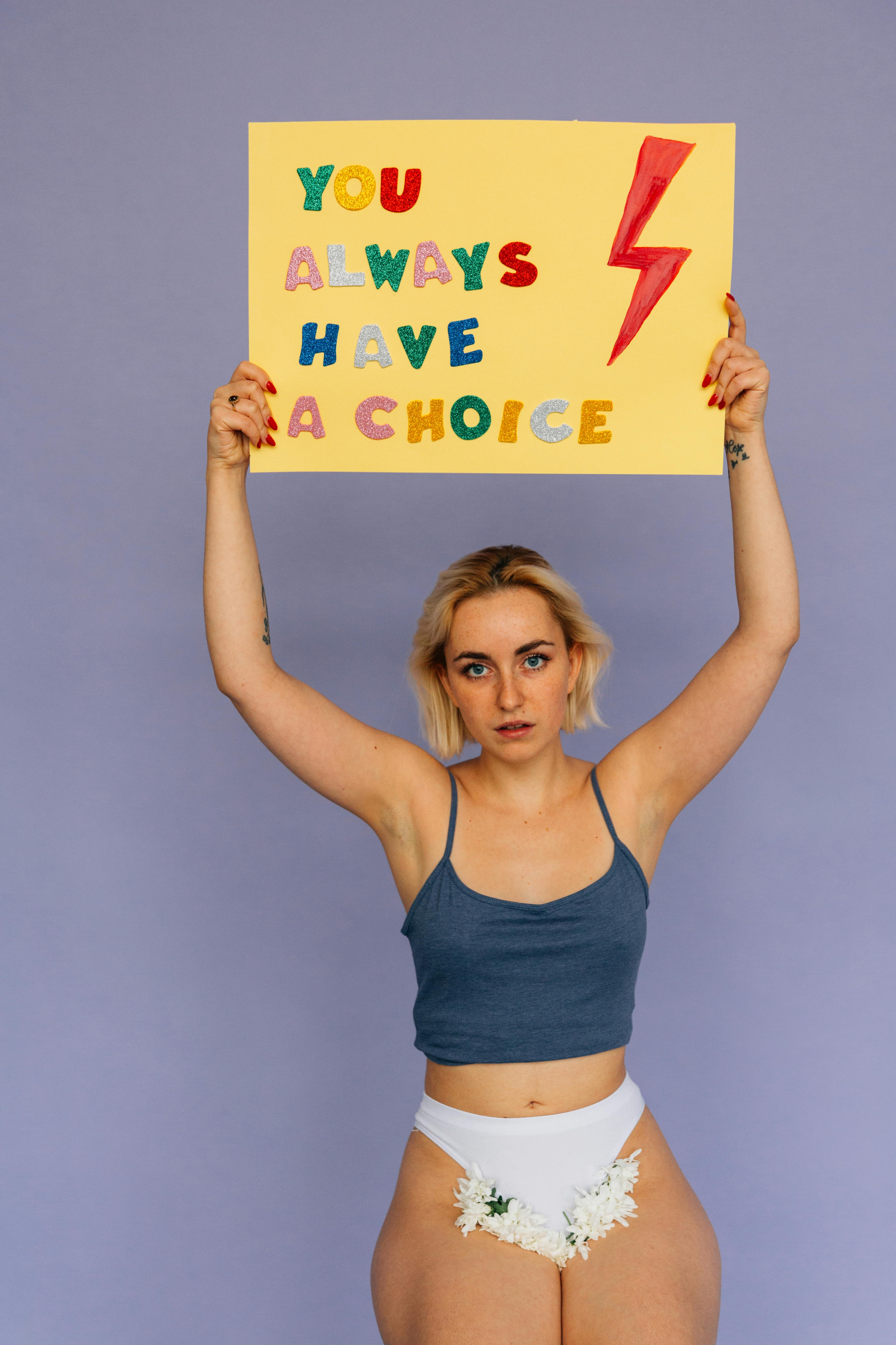 Woman standing with sign 'You Always Have a Choice', symbolizing empowerment and choice.