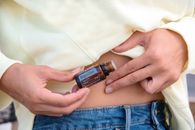 Person Holding Brown Bottle with Essential Oil