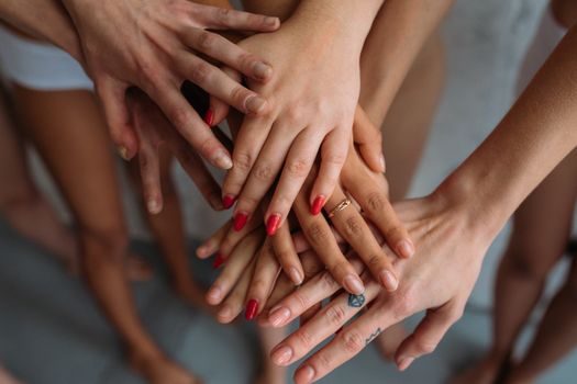 Close-up of diverse hands joined together, symbolizing unity and solidarity.