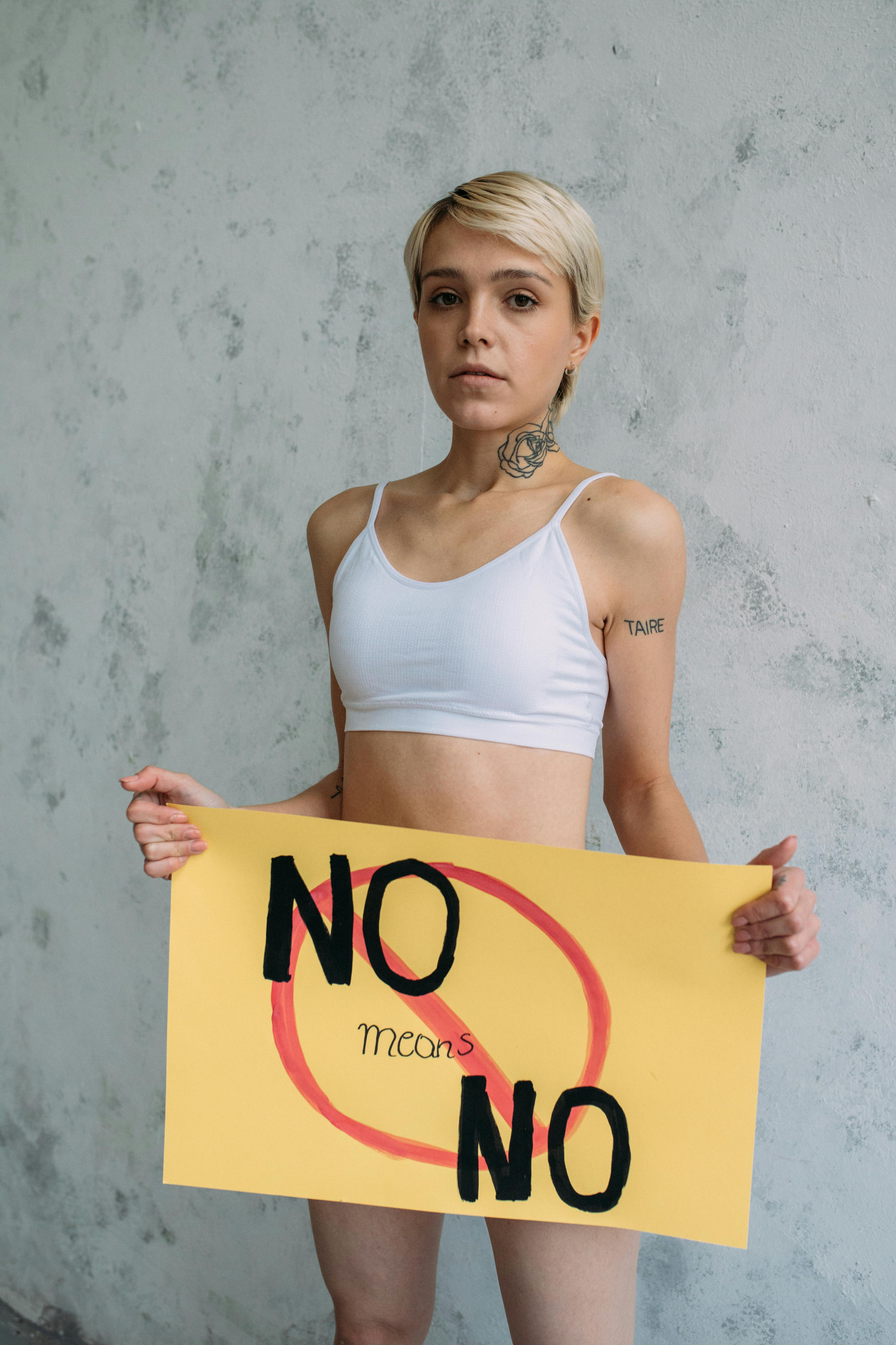 a woman holding yellow paper with message