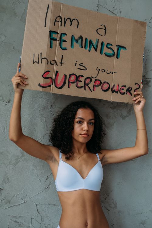 Free Confident woman holding a sign advocating feminism and empowerment. Stock Photo