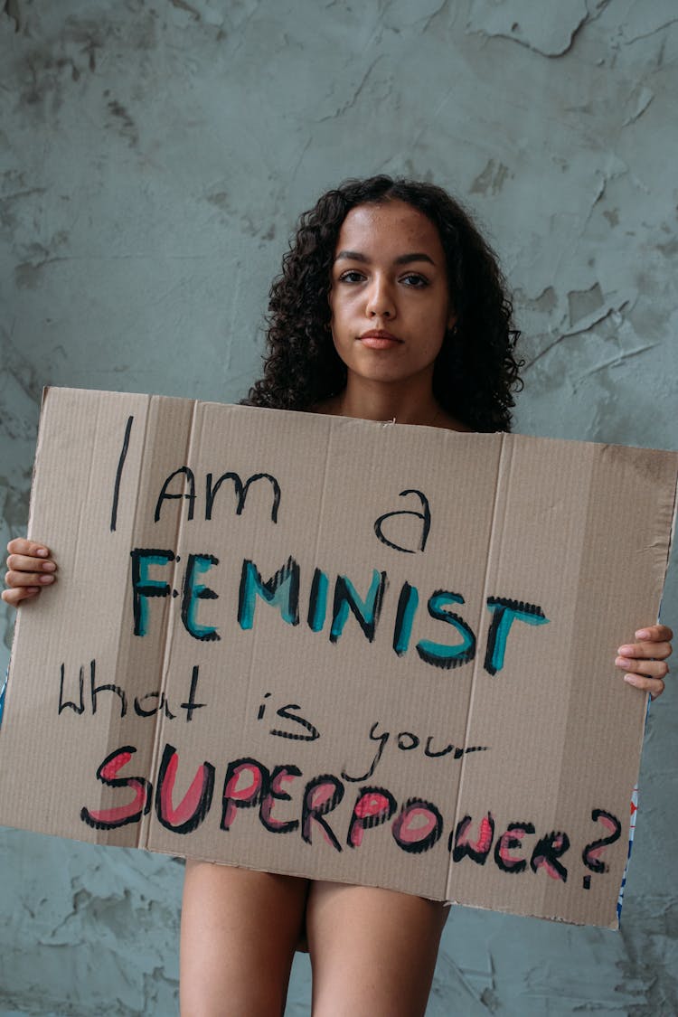 A Woman Holding Banner While Protesting 