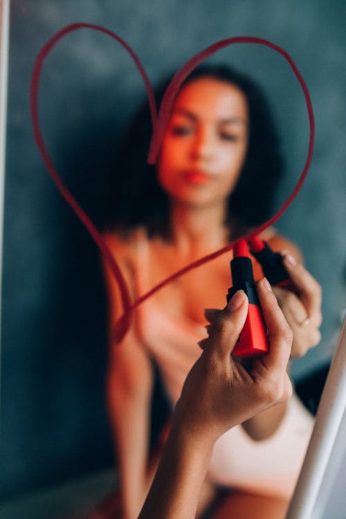 A Woman Holding a Red Lipstick 