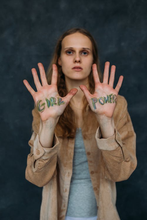 Woman in Brown Jacket With Paint on Hands