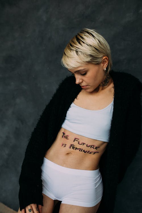 Woman With Short Blond Hair in Black Cardigan and White Crop Top