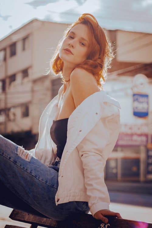 Woman in White Jacket and Blue Denim Jeans
