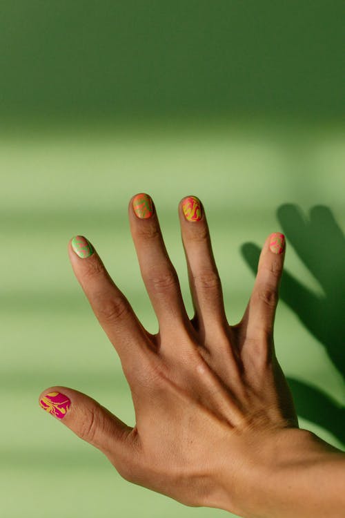 Free Close-Up Shot of a Hand with Colorful Nail Polish Stock Photo