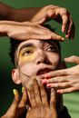Hands with Nail Art on a Man's Face