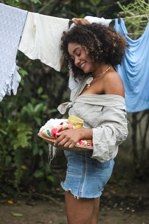 A Woman Looking holding Clothes 