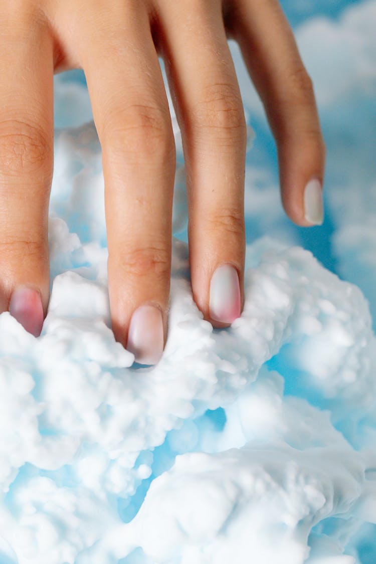 A Hand Touching Shaving Foam