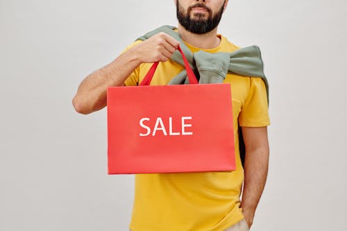Free Man in Yellow Shirt Holding Red Box Stock Photo